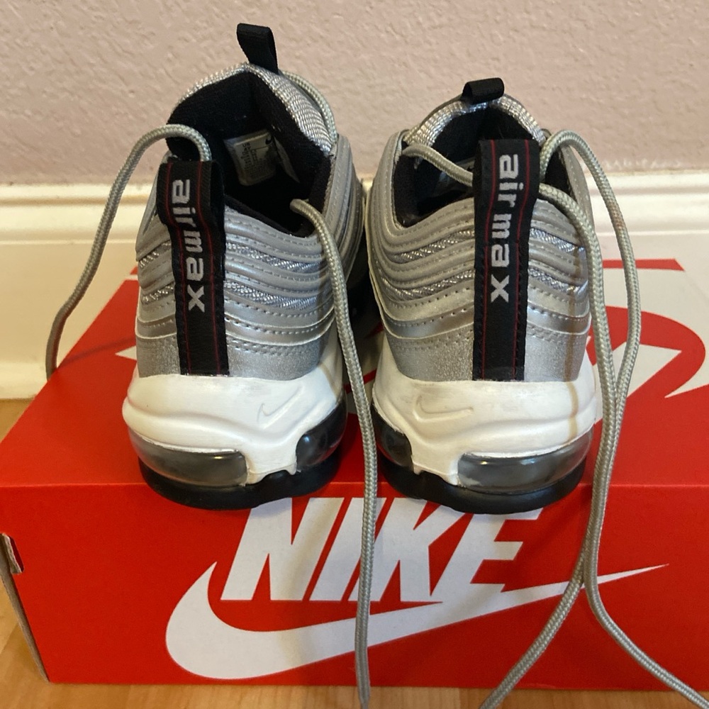 Nike Air Max kids sneakers with metallic accents.